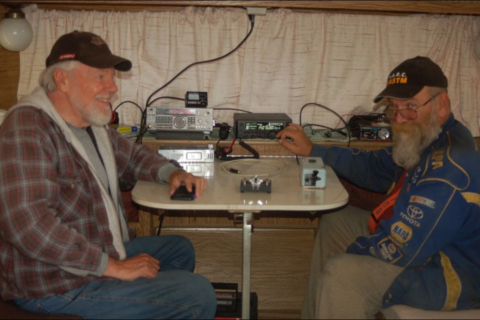 Hooking up connections for the amateur radio field day from left, were: Bob Drayer of Sturgis and Tom Marshall of Hudson Bay.