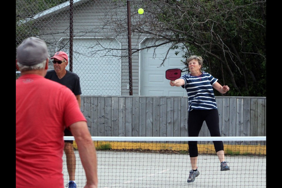 Sandy Montpetit goes airborne to get her paddle on the ball during the Flin Flon/Creighton Pickleball Club clinics at Steventon Park. - PHOTO BY CASSIDY DANKOCHIK