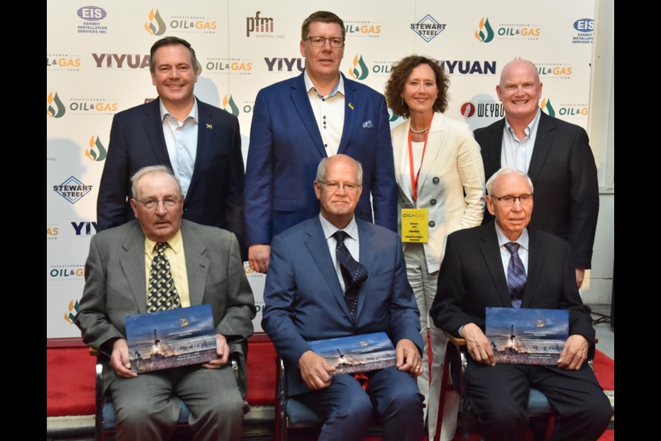 Back row from left: Alberta Premier Jason Kenney, Saskatchewan Premier Scott Moe, Minister of Energy and Resources Bronwyn Eyre, show chair Del Mondor. Front row, from left: Saskatchewan Oil Patch Hall of Fame inductees Ray Frehlick, Dean Potter and Eldon McIntyre.