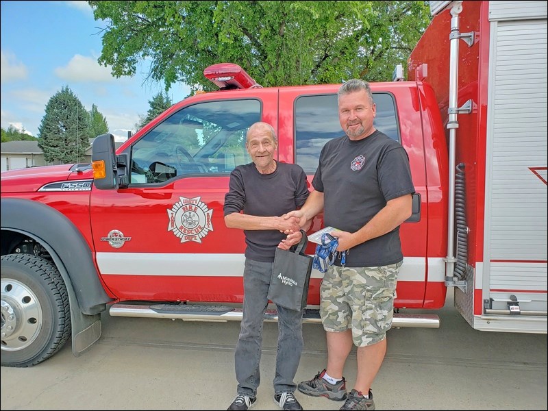 Leo Rocan with Unity Fire Department member Dwaine Kopp, one of the first on the scene of a fire seven years ago in which Rocan was badly burned. Photo by Sherri Solomko