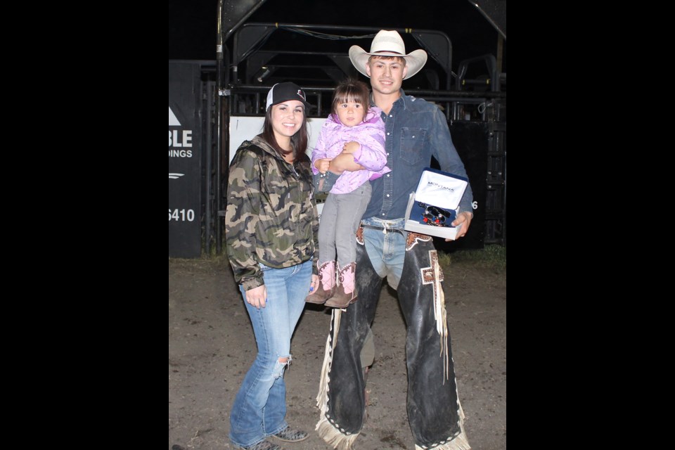 Katrina Zandee (left) and daughter Holly awarding the Manor PBR bull riding winner, Jake Gardner of Fort St. John, BC, the 1st place award. Gardner’s score was 89.5.