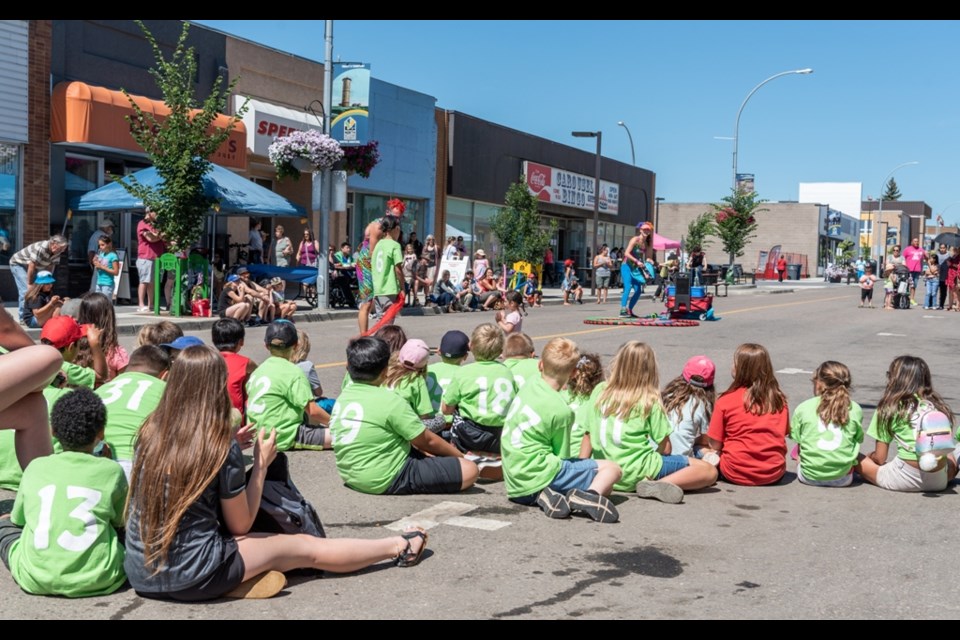 Boys and Girls Club children enjoying the street performer festival.