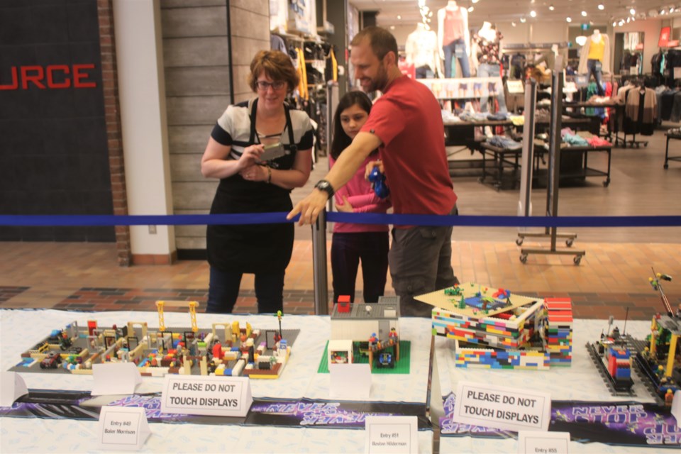 Dustin and Summer Erhardt of Kamsack look at the LEGO display at the Parkland Mall.