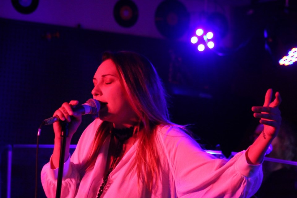 BlackSwan's Jen McLean strikes a pose during a cover of Robert Palmer's "Addicted to Love". - PHOTO BY ERIC WESTHAVER