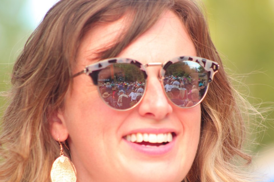 The main stage is reflected in Emily Sparling's sunglasses. - PHOTO BY ERIC WESTHAVER