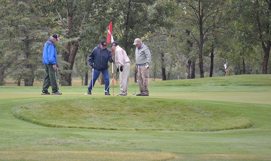 These golfers didn’t let the cold, wet weather dampen their spirits as they help Raise the Roof for the Carlyle Fire Department.