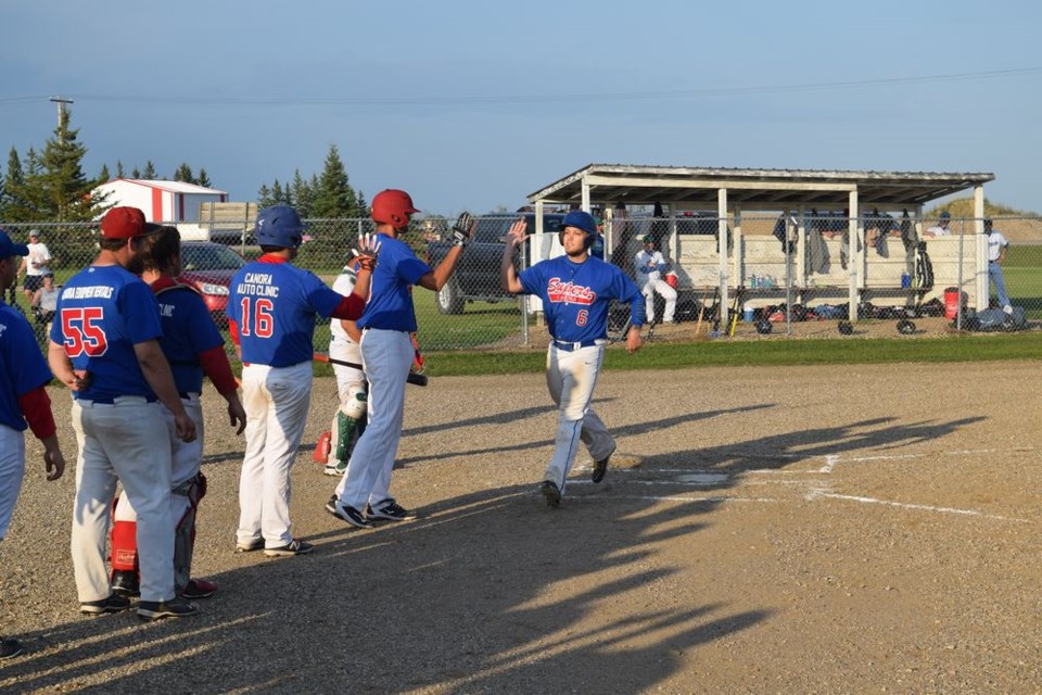After hitting an important three-run home run in game three of the finals, Logan Parachoniak of the Canora Supers crossed the plate and accepted congratulations from his teammates.