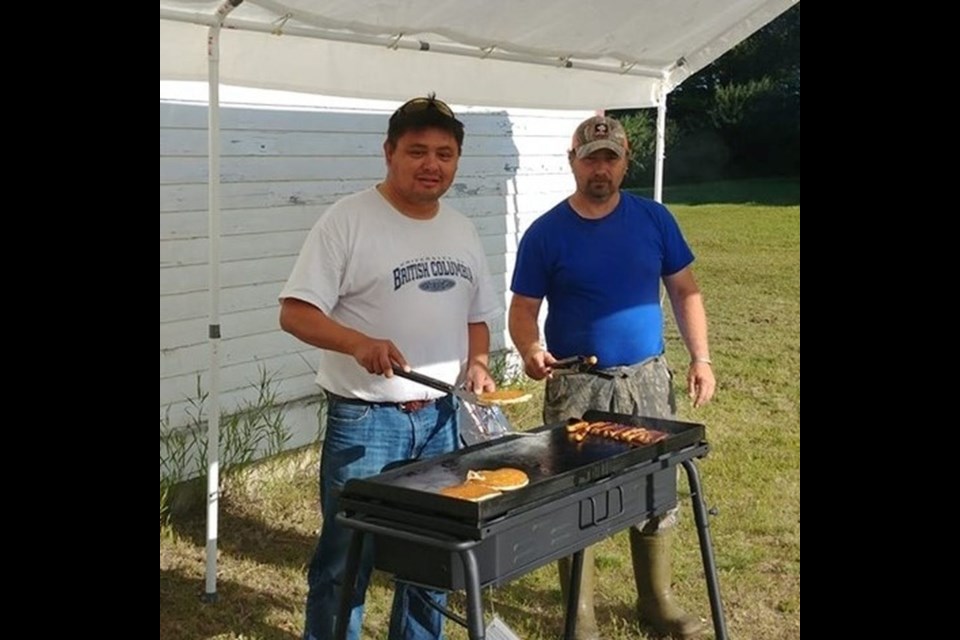 Alvin Quewezance, left, and Scott Green prepared the pancakes and sausages for breakfast on the mornings of the 3-D shoot on July 27 and 28.