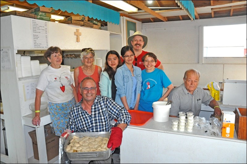 Volunteers at the All Saints Ukrainian Catholic Parish booth at North West Territorial pause during