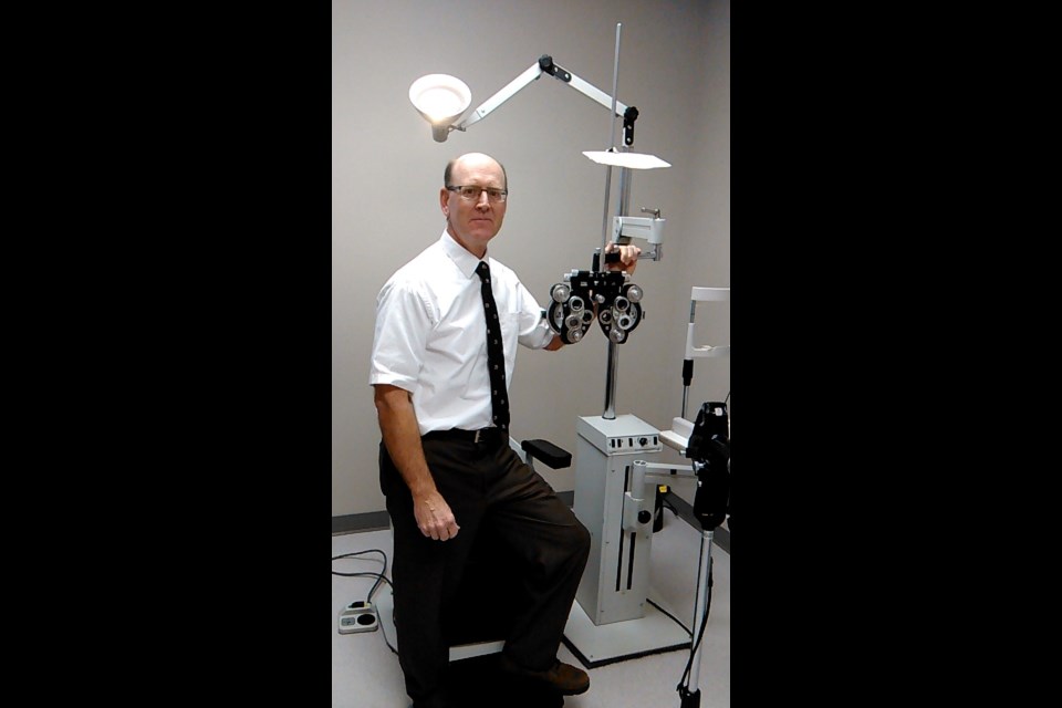 Dr. Ray Moser with one of the machines he worked with as an optometrist. Photo submitted