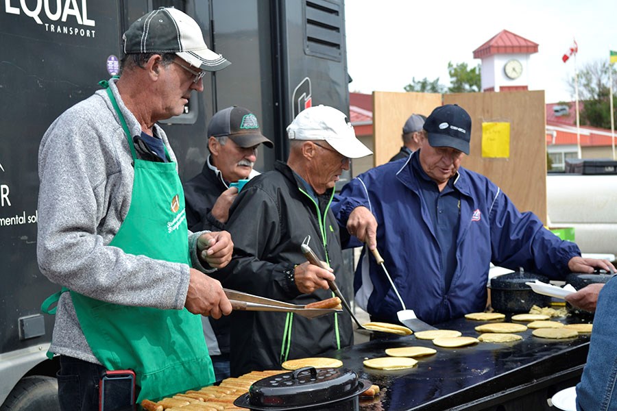 (l-R) Lions Craig Savill, Gerald Clark, Ted O’Neill and Kalvin Luedtke man the grill at the Carlyle Lions Club Pancake Breakfast during Carlyle Fun Dayz.