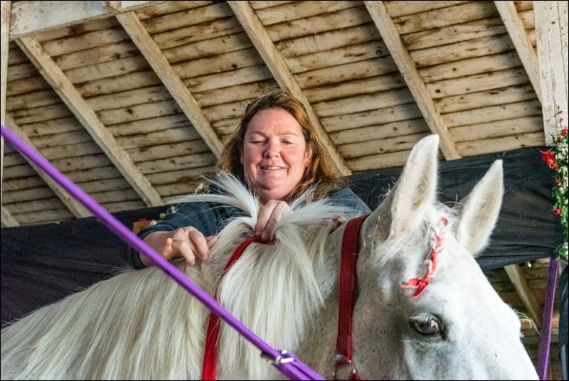 Erin Mitchell, chair of the draft horse committee for North West Territorial Days, braiding a mane. All photos by Averil Hall. * Please note these photos carry the photographer's copyright and may not be reproduced from this gallery. For print requests, visit https://www.mphocus.com/