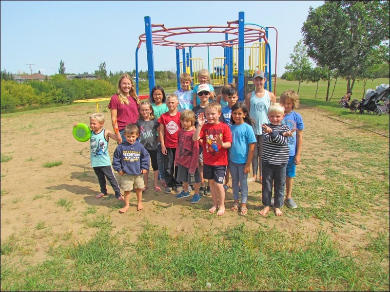 Danika Pidwerbesky and Sydney S with the children from the Borden Library Summer Program playing at the school yard. Photos by Lorraine Olinyk