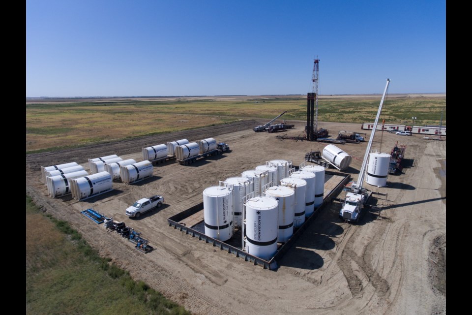 It might be a geothermal project, but all the service providers are oilpatch related, and most come from Estevan. In this picture, the service rig is from Independent Well Servicing, the tanks and containment come from Black Diamond, the bed truck and foreground picker are Camion Trucking, the distant picker is from Bert Baxter Transport. A few days earlier, the mud being mixed in the tank came from Prairie Mud, and L&C Trucking had brought in the tubing.