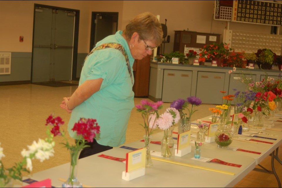 Heather Bartch looked closely at all the flowers and vegetables on display.