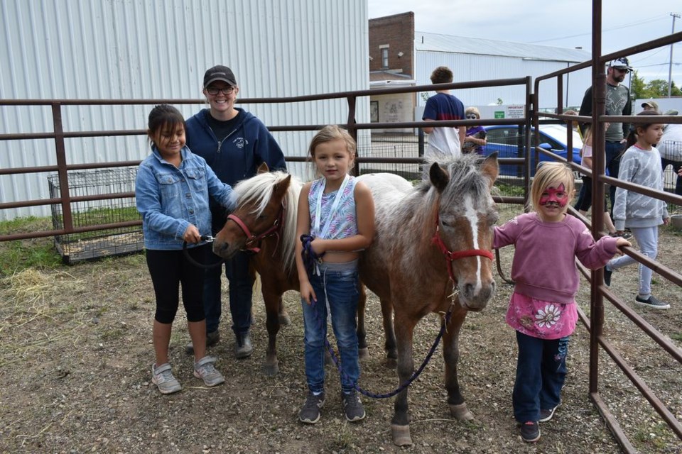 Amanda Burback had her ponies, Joey (smaller brown) and Summer at the Street Fest petting zoo. Quinn Keshane, Lacy Keshane and Christina Kulak had fun petting the ponies.