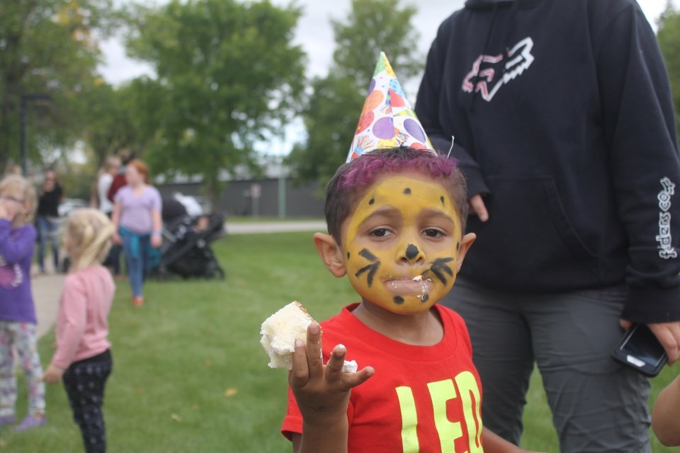 Marley Kamang enjoys a piece of cake at the birthday party for Cooper, the Beeland Co-op’s mascot, and Fat Cat, the Cornerstone Credit Union’s mascot, on Aug. 29. Photo by Jessica R. Durling