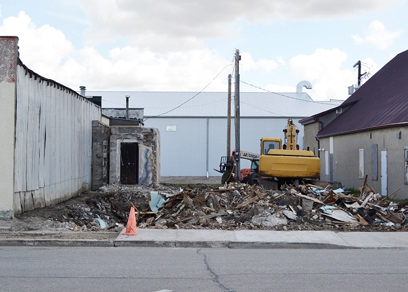 The face of Main Street in Carlyle has been changed as a piece of history was demolished on Sunday, Aug. 25. Originally the home of the Royal Bank, which was built in approximately 1917, the building went on to house the R.M. of Moose Mountain #63 and then offices. Ron Kyle has owned the building for 57 years and said that the time had come when the cost of repairs outweighed the usefulness of the building so he arranged to have it demolished before it became a hazard.