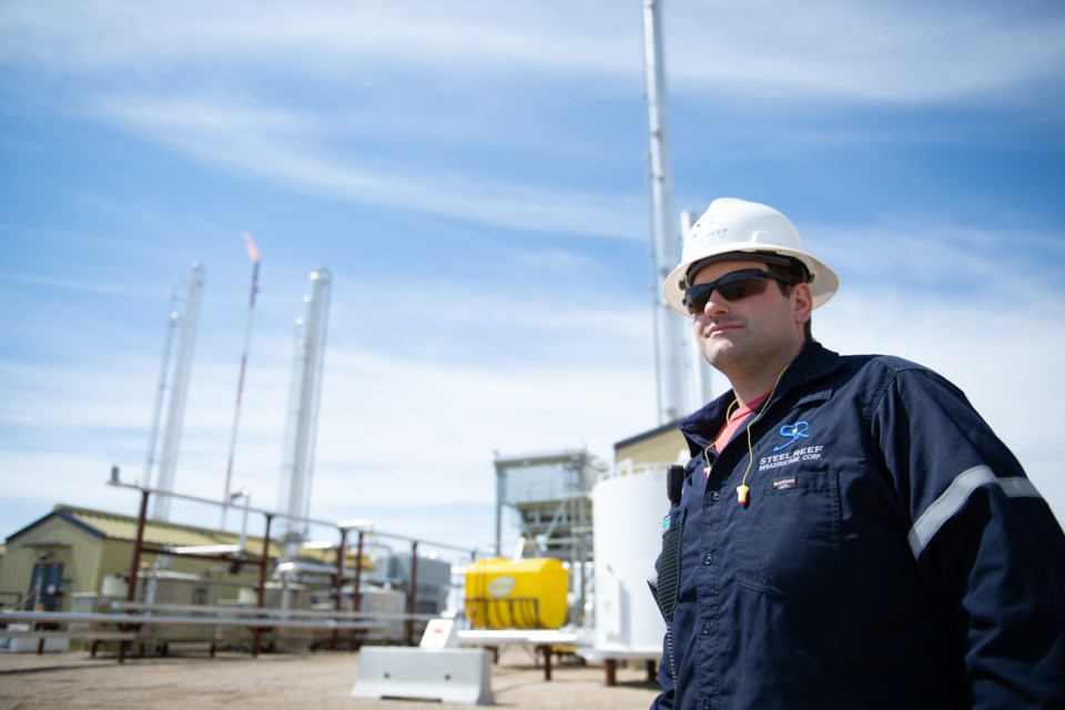 Derek Fichter stands before the Steel Reef Alameda gas plant.