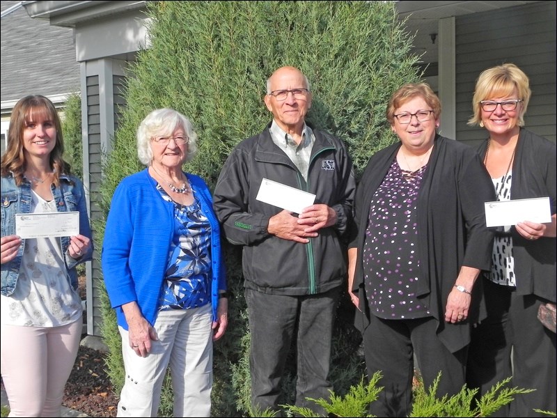 Brianna Heck, representing Unity long term care activities, Pauline Volk, representing her husband the late Nick Volk, co-chair of 2005 German Pavilion, Mayor Ben Weber representing the Richardson Outdoor Recreation Park, Yvonne Greenwald, co-chair of the 2005 German Pavilion and Paula Sittler, representing Parkview Place activities, were all smiling at the surprise gesture from the organizers of the 2005 German Pavilion held in Unity that generated surplus funds being distributed to these three beneficiaries. Photo by Sherri Solomko