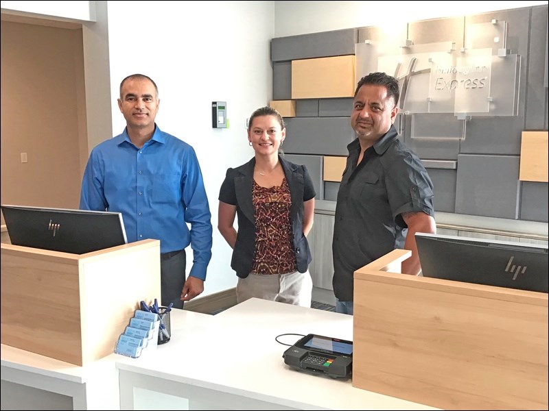 Amrinder Gill, general manager, Jenni Wuttunee, director of sales, and Gary Brar, owner, are seen at the new Holiday Inn Express and Suites hotel in North Battleford. The new hotel, which features a breakfast area and swimming pool, is now accepting guests. The grand opening is set for Friday. Photos by John Cairns