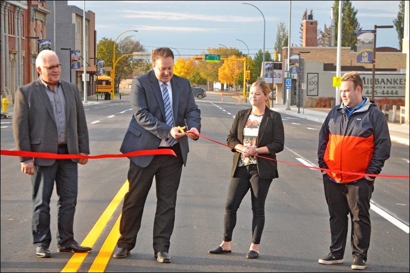 Councillor Greg Lightfoot, Mayor Ryan Bater, Councillor Kelli Hawtin, and Councillor Kent Lindgren at the ribbon cutting to re-open 100th Street Thursday morning at 8 a.m. Photo by John Cairns