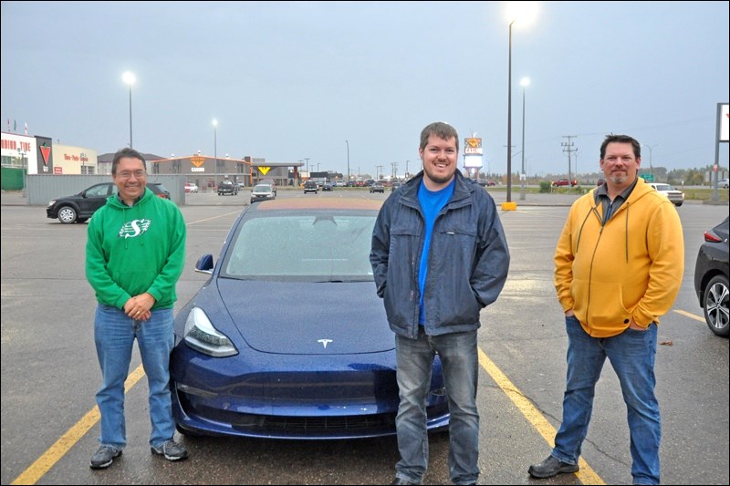 Dave Maenz, Jason Cruickshank and Russell Lepage pose during a rainy evening in which they answered