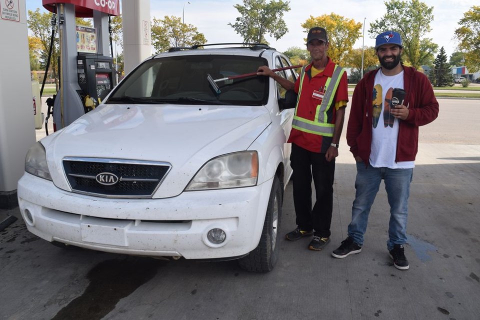 At Co-op Fuel Good Day in Canora on September 17, Oliver Vieira (right) had his gas tank filled and his windshield cleaned by Michael Skibinsky. During the event, 10 cents per litre was donated to the Canora and District Benevolent Fund Association.