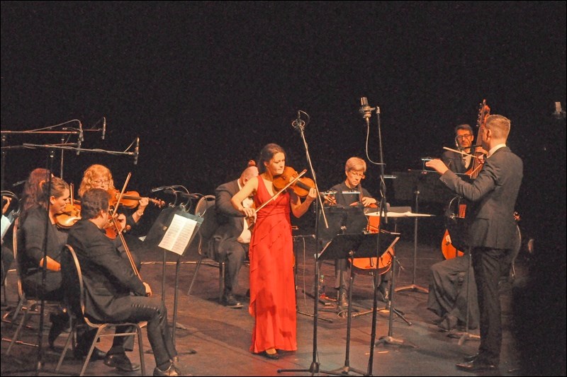 The Saskatoon Symphony Orchestra under the direction of Eric Paetkau, featuring violinist Veronique Mathieu at the Dekker Centre Sunday. The microphones, normally unnecessary, were in place for recording by SaskTel Max. Photos by Jayne Foster