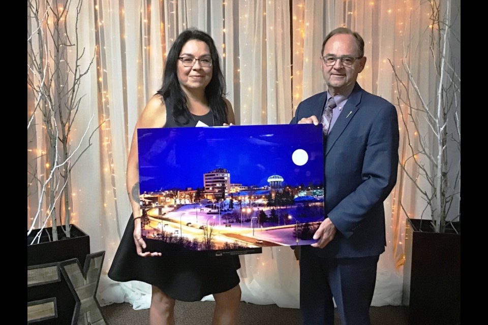 Battlefords MLA Herb Cox, representing SaskTel, presents the BBEX Business of the Year award to Ursula Swindler, manager of Capitol Theatre. Photo by John Cairns