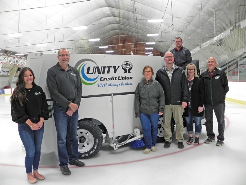 Shown here are representatives from Unity Credit Union presenting $25,000 to Mayor Ben Weber as contributions towards the new Zamboni now in use at the Unity arena. Photo submitted by Sherri Solomko