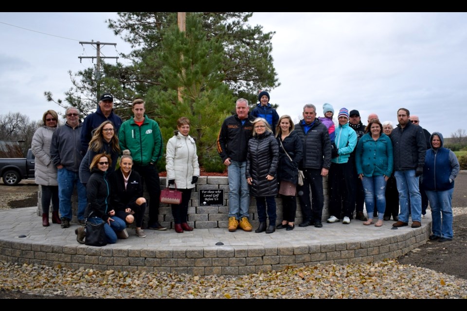 Richie Weiler, Art Wrubleski and Susan Sands' families, friends and colleagues gathered in front of the TS&M Woodlawn Golf Club’s memorial wall. Photo by Anastasiia Bykhovskaia