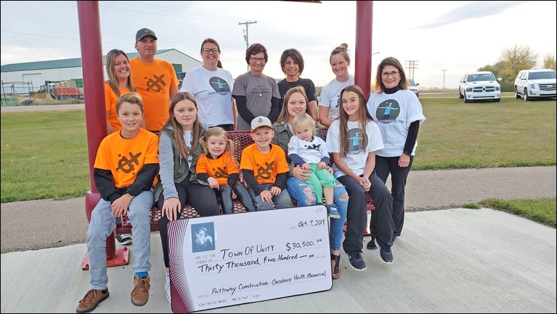 Heitt family and friends gathered to present funds from eight years of the Candace Heitt Memorial Marathon event to the Town of Unity for paved pathways at the Unity Health Centre and the Unity Regional Park ball diamonds. Photo by Sherri Solomko.