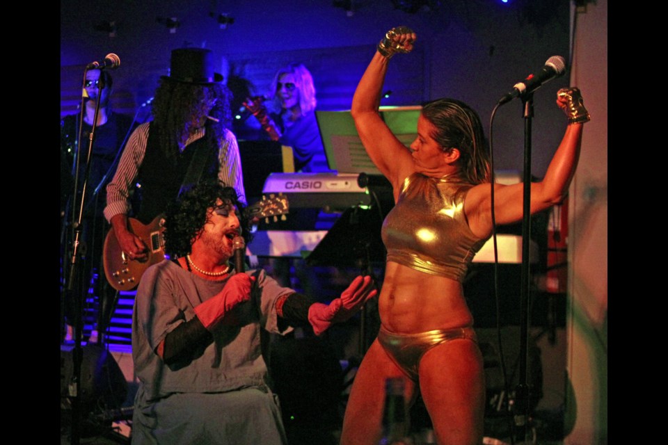 Miranda Bowman flexes as she plays the titular Rocky in the production of the Rocky Horror Show at Johnny’s Social Club. CC Trubiak played Dr. Frank N. Furter, the mad alien scientist who creates Rocky during the show. Photo by Cassidy Dankochik.