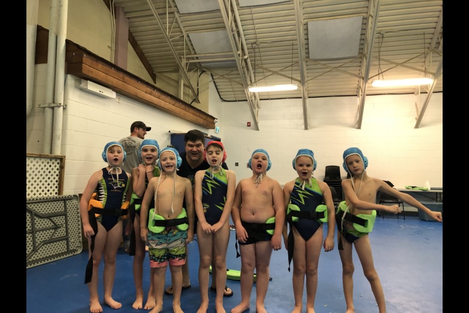 Mini Mako Sharks members are Alexa Groshong, Blaire Wilson, Penn Tytlandsvik, coach Chad Knoll, Willow Turner, Parker Moffatt, Meredith Knoll, Carson Threinen.
