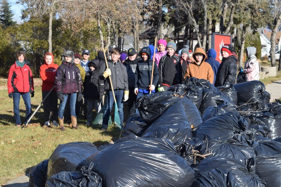 This group of CCS students and their supervising teachers paused for a picture with the bags of leaves they cleaned off the grounds at King George Park on October 23.