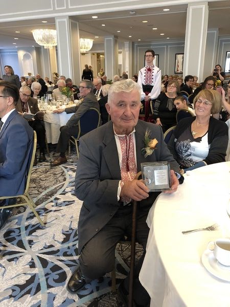 Eddie Diakow displayed his award while his wife Charlotte, right, looked on.