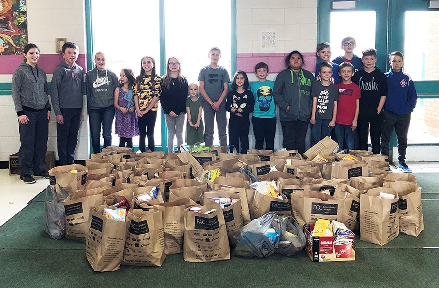 Farm Credit Corporation recently visited three area schools, whose students helped in collecting food for their Drive Away Hunger campaign. All proceeds went to the Carlyle Food Bank. In this photo students from Carlyle Elementary School pose with their collection of food items for the cause.