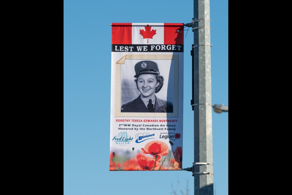A banner featuring Dorothy Teresa Edwards Northcott displayed prominently in front of the pharmacy on main street in Battleford.