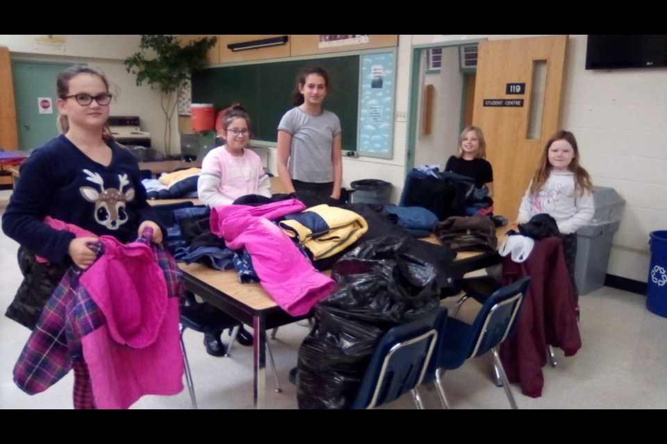 The Canora Homecraft 4-H Club Coats for Kids campaign is accepting donations of winter coats and other warm clothing for those in need. Club members have been going through donated items looking for those in need of repairs. From left, were: Jasmine Wasyliw, Natalie St. Mars, Falyn Ostafie, Isabelle Chabun and Eva Burkatsky.