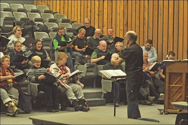 Rehearsals are well underway on Wednesday nights at the North Battleford Comprehensive High School, where singers have been preparing for the Candlelight Processional happening later in November. Director Stephen Carter is seen here directing the choir members during the rehearsal session in the lecture theatre. Photo by John Cairns