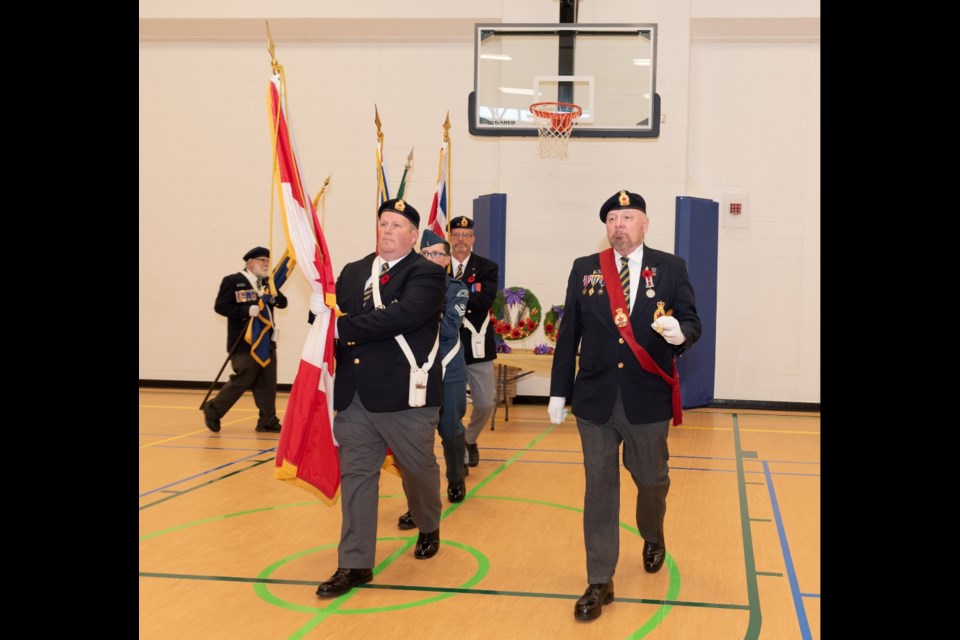 The Colour Guard marches in the Colours.