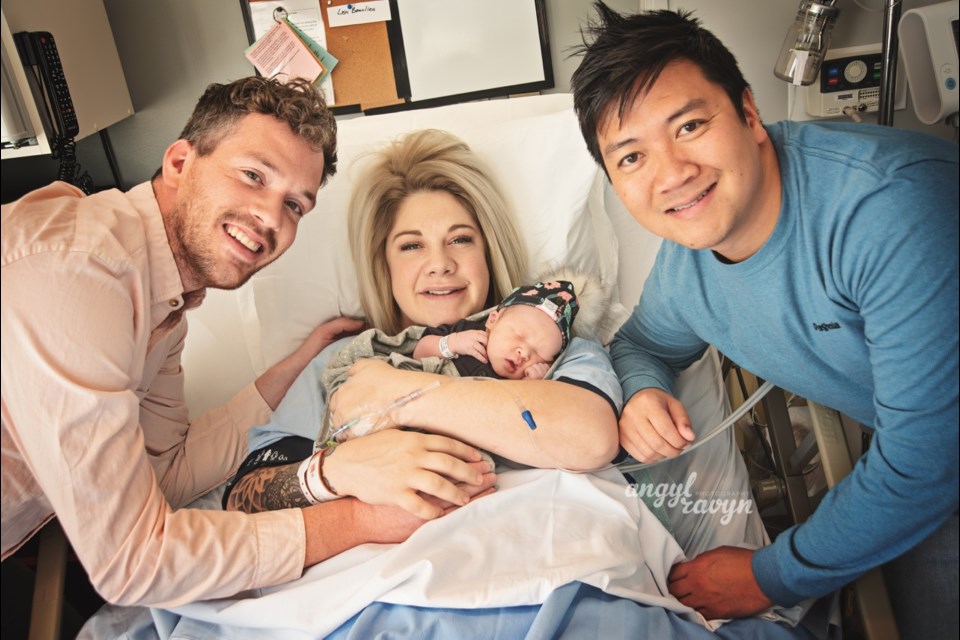 Tim Bangsund, Lisa Beaulieu and Chewn Bangsund gather for a photo with Florence Juniper Pham Bangsun. Florence was born on Nov. 6. Lisa served as the surrogate for the Bangsunds. Photo by Angyl Ravyn Photography