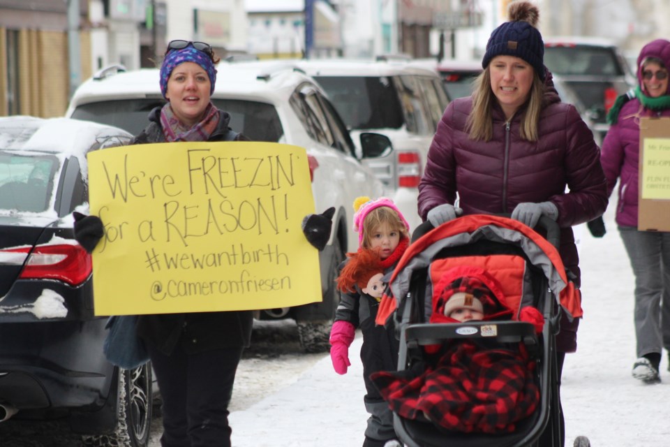 Kirsten Fritsch and Kate Starkey march during the We Want Birth obstetrics demonstration Nov. 15. Starkey’s son Adam (in the stroller) was the last child born in Flin Flon before the suspension of obstetric care at Flin Flon General Hospital one year ago. - PHOTO BY ERIC WESTHAVER