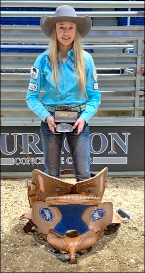 Kaybree Zunti, shown here with the championship buckle and saddle she won as junior barrel racing ch