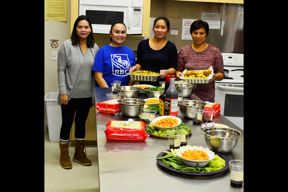 (L to R) Richel Subere, Sarah Villamar, Rosales Busog and Kristina Villeta prepared a delicious meal at the Philippine cooking class held Nov. 14 at the Carlyle Memorial Hall.