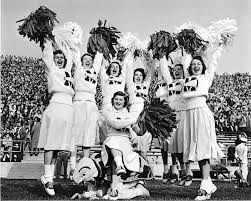 Notice the saddle shoes!And the pom-poms! Since pom-poms were documented as entering the cheerleadin