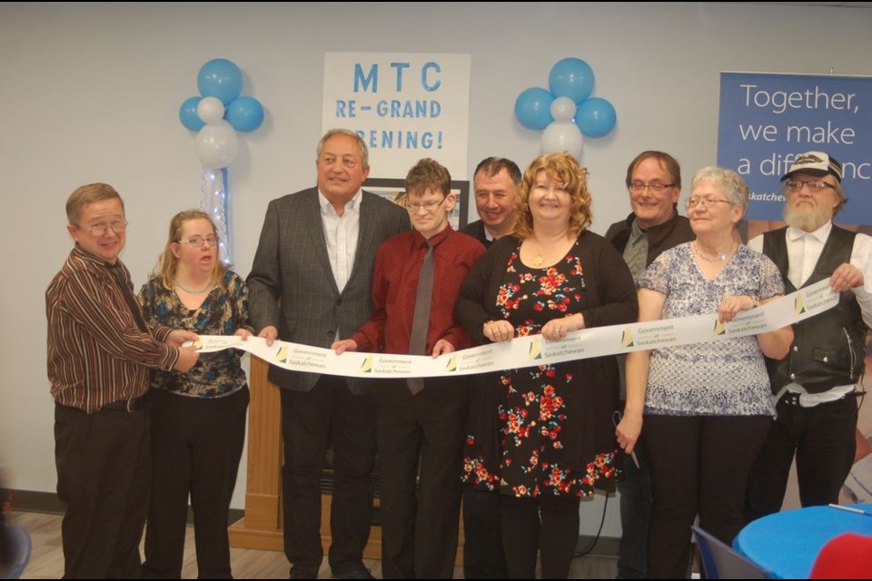 Helping to cut the ribbon at the unveiling of the newly renovated day program with Mackenzie Society Ventures Inc. (MSVI) in Preeceville on November 15, from left, were: Mark Dolton, Kelly Poroznuk, Terry Dennis, Canora-Pelly MLA, Corey Killniak, Ronnie Shewchuk, Gailene Pasiechnik, Mayor Garth Harris, Jackie Blotski and Dennis Knezacek.