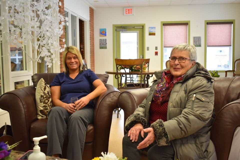 Amanda Yaremko (activity worker) left, chatted with Ev Banks (Eaglestone board member) at the Eaglestone Lodge open house on November 20.