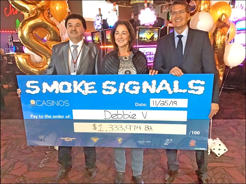 Gold Eagle Casino general manager Kelly Atcheynum, Smoke Signals jackpot winner Debbie Vidal, and SIGA president Zane Hansen were at the Smoke Signals grand prize announcement at the casino Thursday. Photo by John Cairns